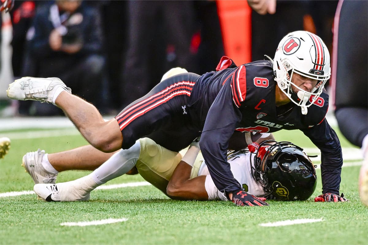 Colorado Buffaloes running back Dylan Edwards (3) gets tackled by Utah Utes safety Cole Bishop (8) at Rice-Eccles Stadium. 