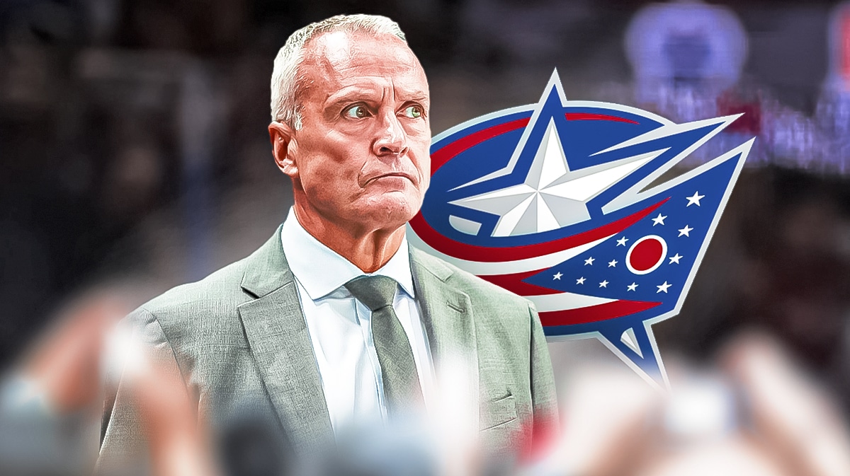 Dean Evason in front of Columbus Blue Jackets logo