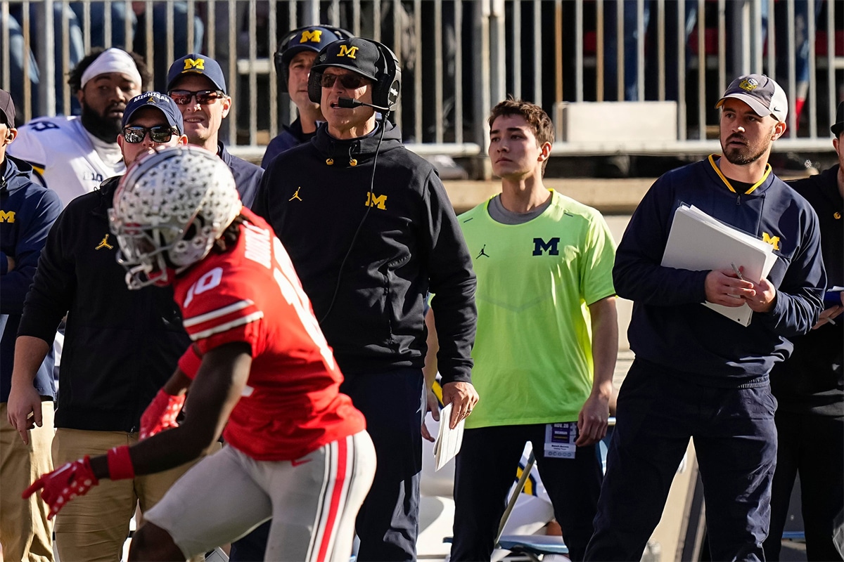 Michigan Wolverines head coach Jim Harbaugh watches from the sideline beside off-field analyst Connor Stalions, right, during the NCAA football game against the Ohio State Buckeyes