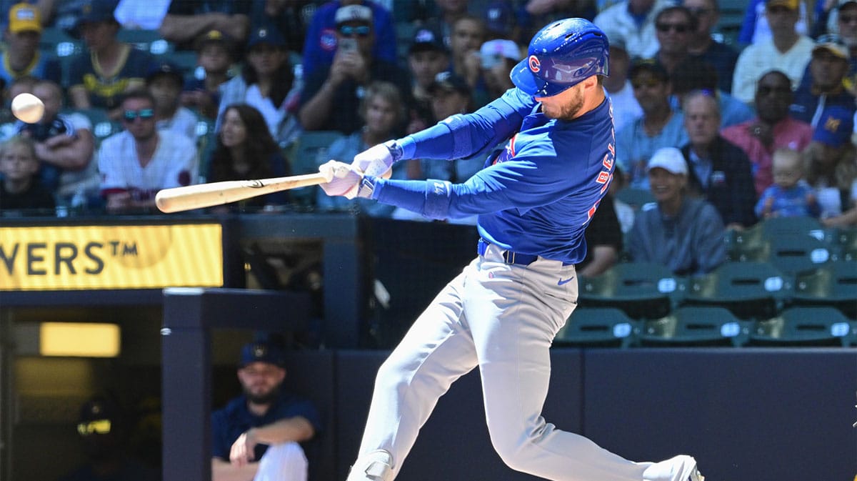 Chicago Cubs designated hitter Cody Bellinger (24) hits a single against the Milwaukee Brewers in the first inning at American Family Field.