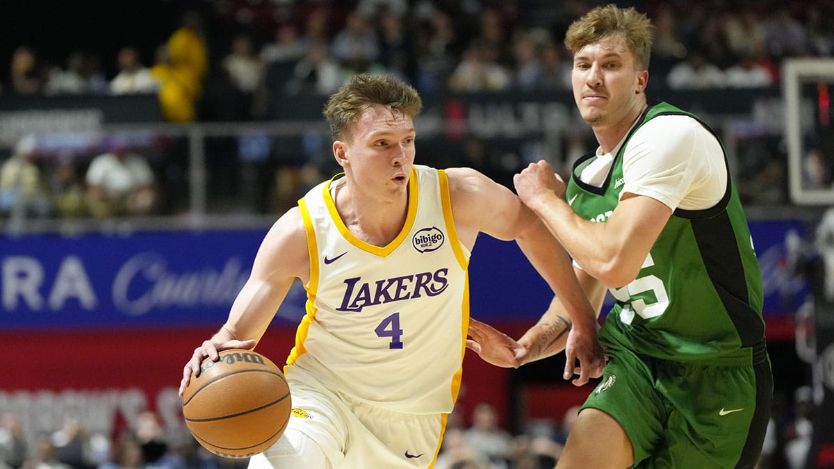Los Angeles Lakers forward Dalton Knecht (4) drives the ball against Boston Celtics guard Baylor Scheierman (55) during the first half at Thomas & Mack Center. 