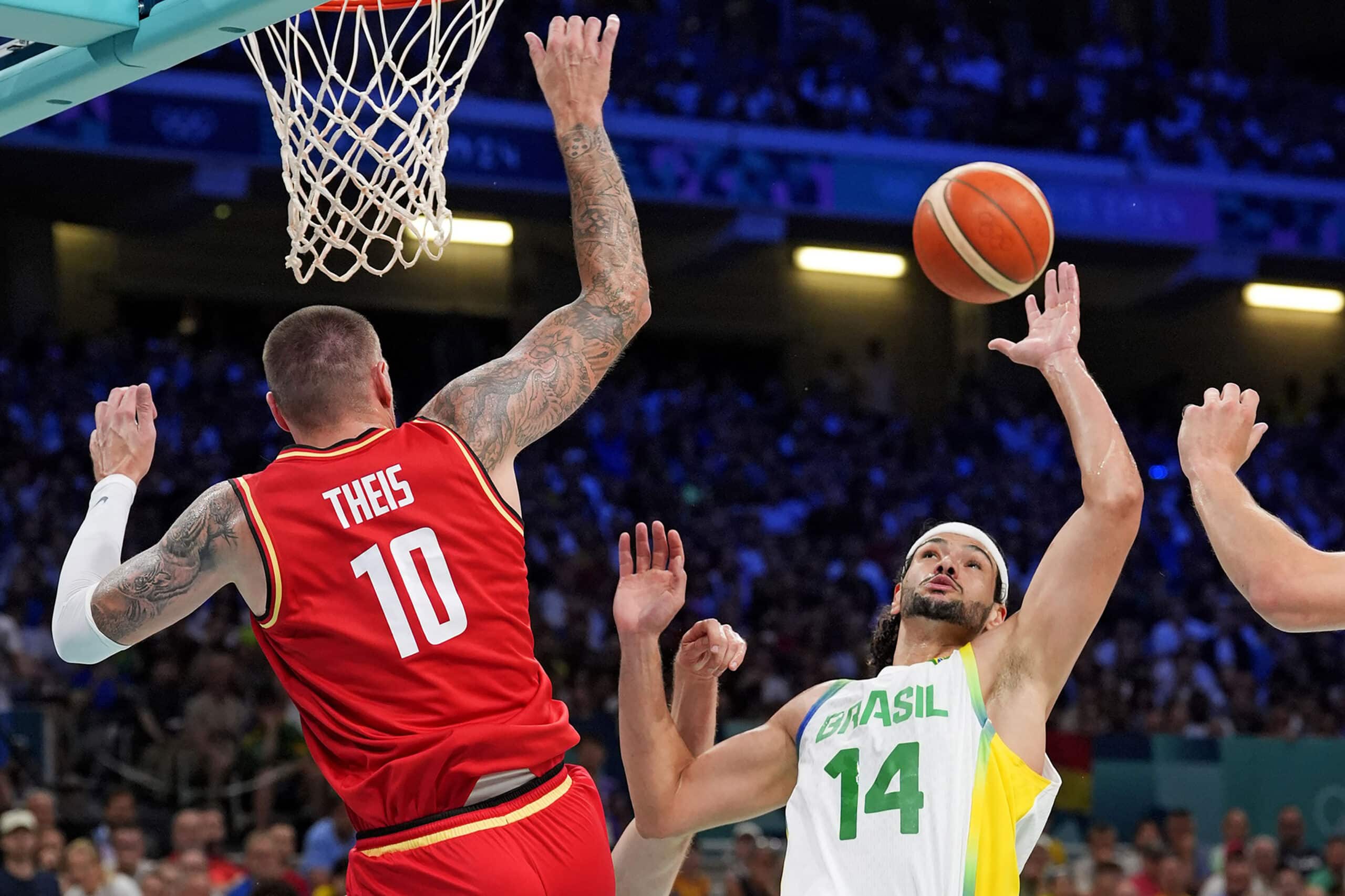 Germany power forward Daniel Theis (10) and Brazil small forward Leo Meindl (14) go for the ball in men’s basketball group B play during the Paris 2024 Olympic Summer Games at Stade Pierre-Mauroy. 