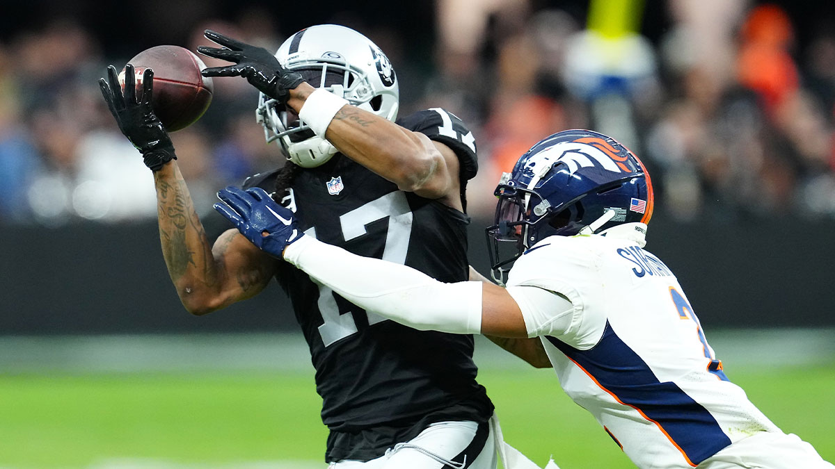 as Vegas Raiders wide receiver Davante Adams (17) makes a catch against Denver Broncos cornerback Pat Surtain II (2) during the second quarter at Allegiant Stadium.