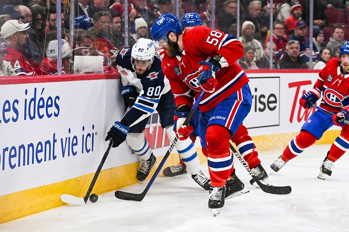 Winnipeg Jets left wing Pierre-Luc Dubois (80) plays the puck against Montreal Canadiens defenseman David Savard (58) during the third period at Bell Centre.