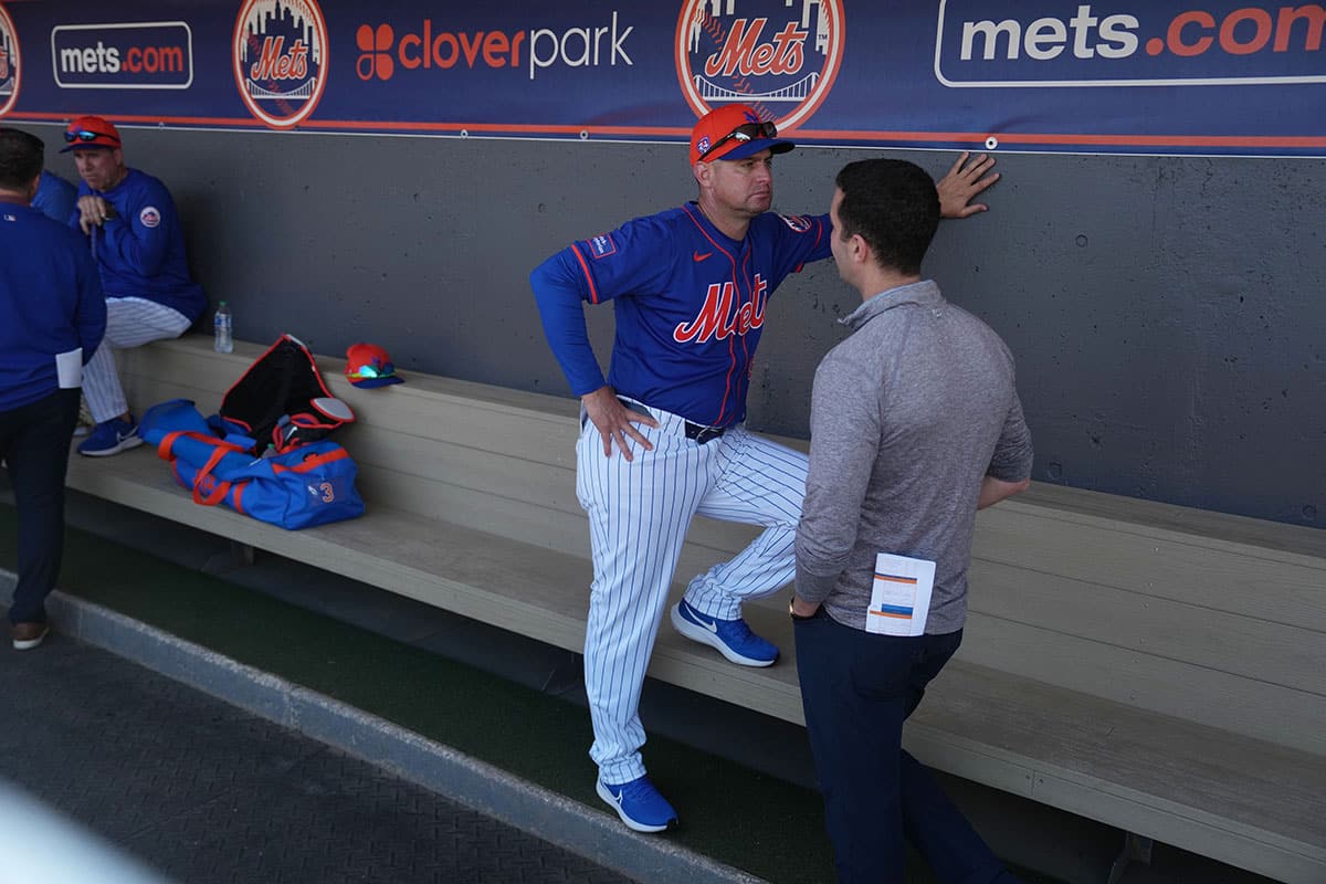 New York Mets president of baseball operations, David Stearns, right, speaks with manager Carlos Mendoza during workouts at spring training.
