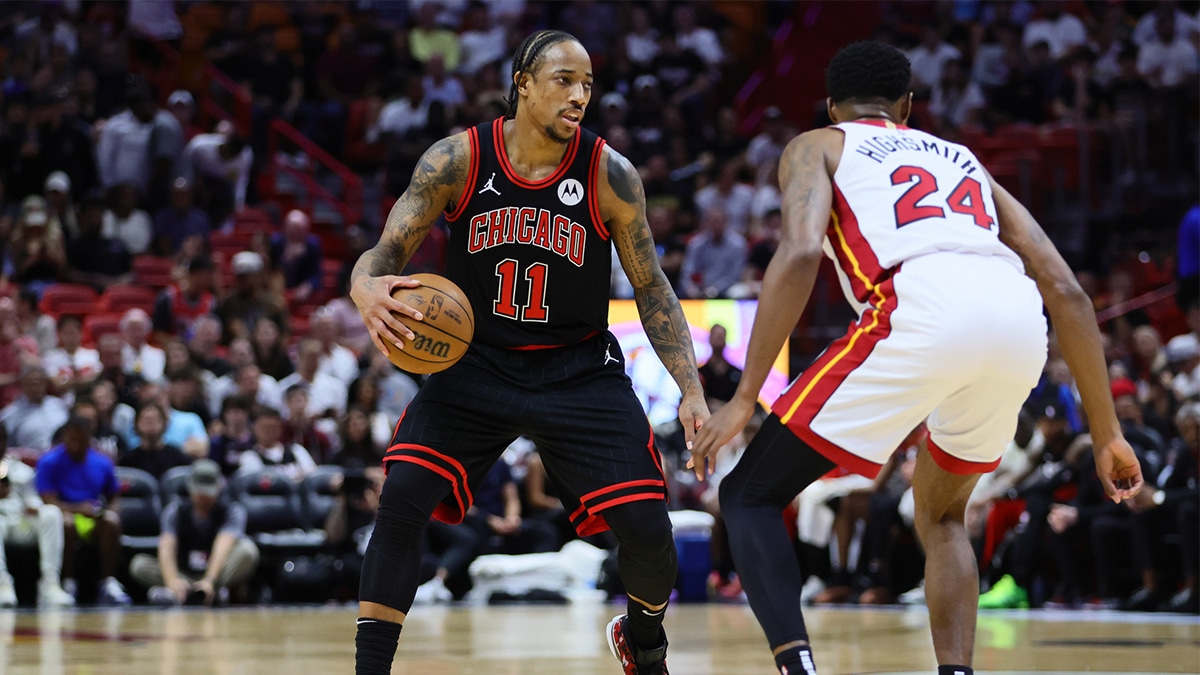 Chicago Bulls forward DeMar DeRozan (11) dribbles the basketball as Miami Heat forward Haywood Highsmith (24) defends in the first quarter during a play-in game of the 2024 NBA playoffs at Kaseya Center. 