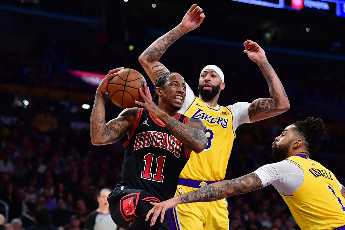 Chicago Bulls forward DeMar DeRozan (11) moves the ball against Los Angeles Lakers forward Anthony Davis (3) and guard D'Angelo Russell (1) during the second half at Crypto.com Arena.