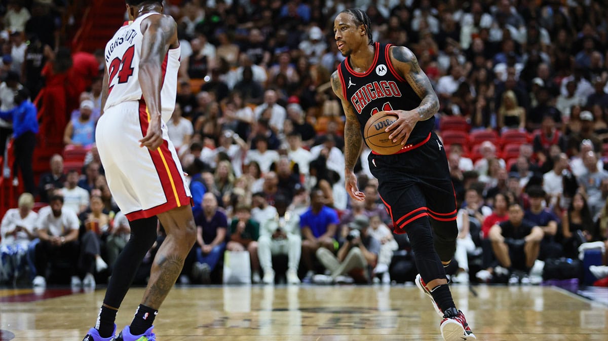 Chicago Bulls forward DeMar DeRozan (11) dribbles the basketball against the Miami Heat in the second quarter during a play-in game of the 2024 NBA playoffs at Kaseya Center.