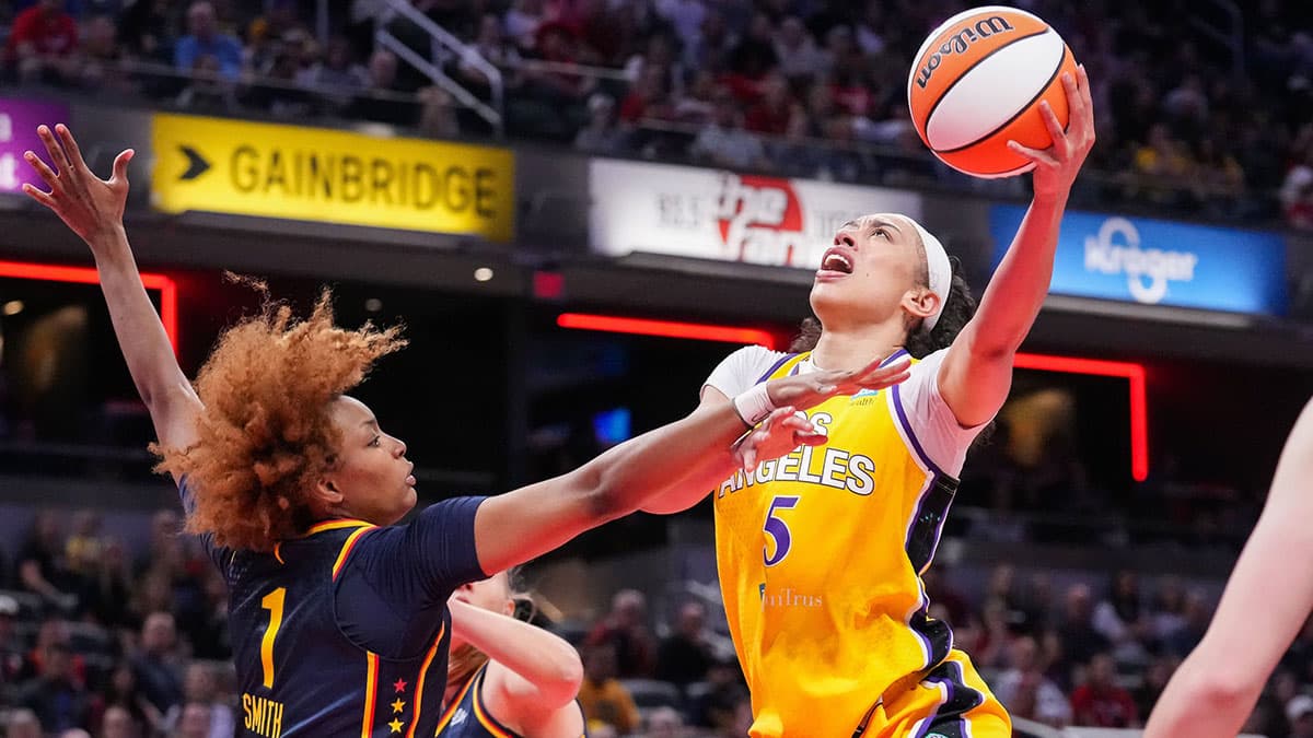 Los Angeles Sparks forward Dearica Hamby (5) goes in for a lay-up against Indiana Fever forward NaLyssa Smith (1) on Tuesday, May 28, 2024, during the game at Gainbridge Fieldhouse in Indianapolis.