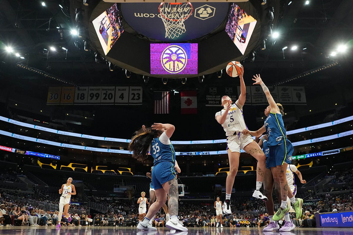 LA Sparks forward Dearica Hamby (5) shoots the ball against Minnesota Lynx guard Natisha Hiedeman (2) and forward Alissa Pili (35) in the second half.