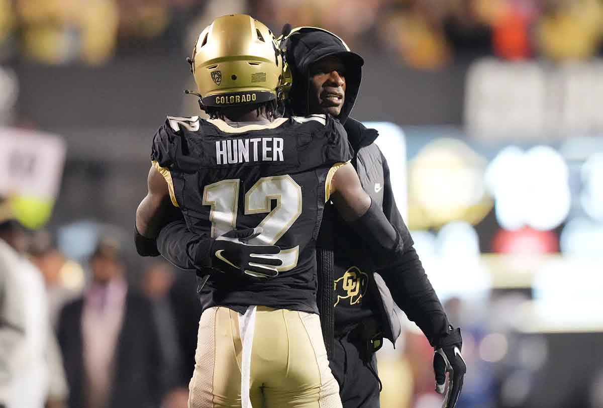 Colorado Buffaloes wide receiver Travis Hunter (12) is congratulated for his touchdown by head coach Deion Sanders in the first quarter against the Stanford Cardinal at Folsom Field. 