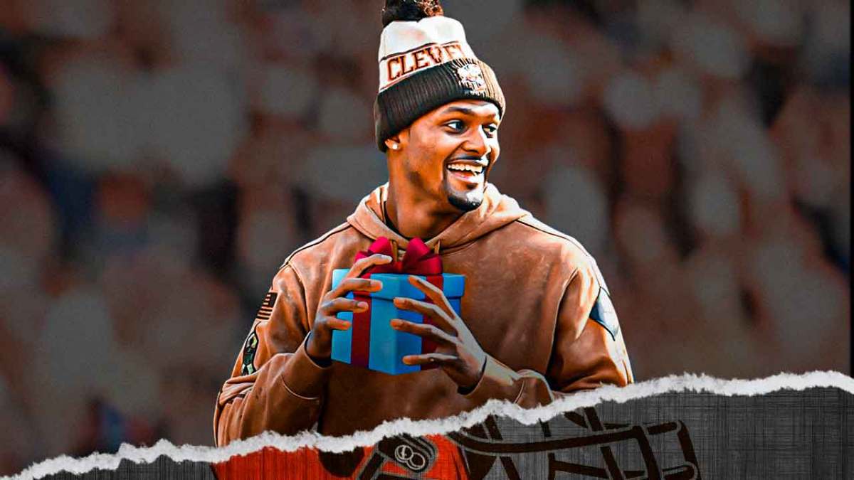Deshaun Watson smiling holding a present.