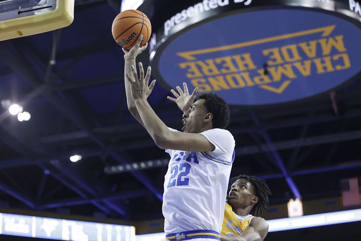 UCLA forward Devin Williams (22) attempts a shot as Long Island University guard Eric Acker (2) defends during the second half at Pauley Pavilion presented by Wescom.