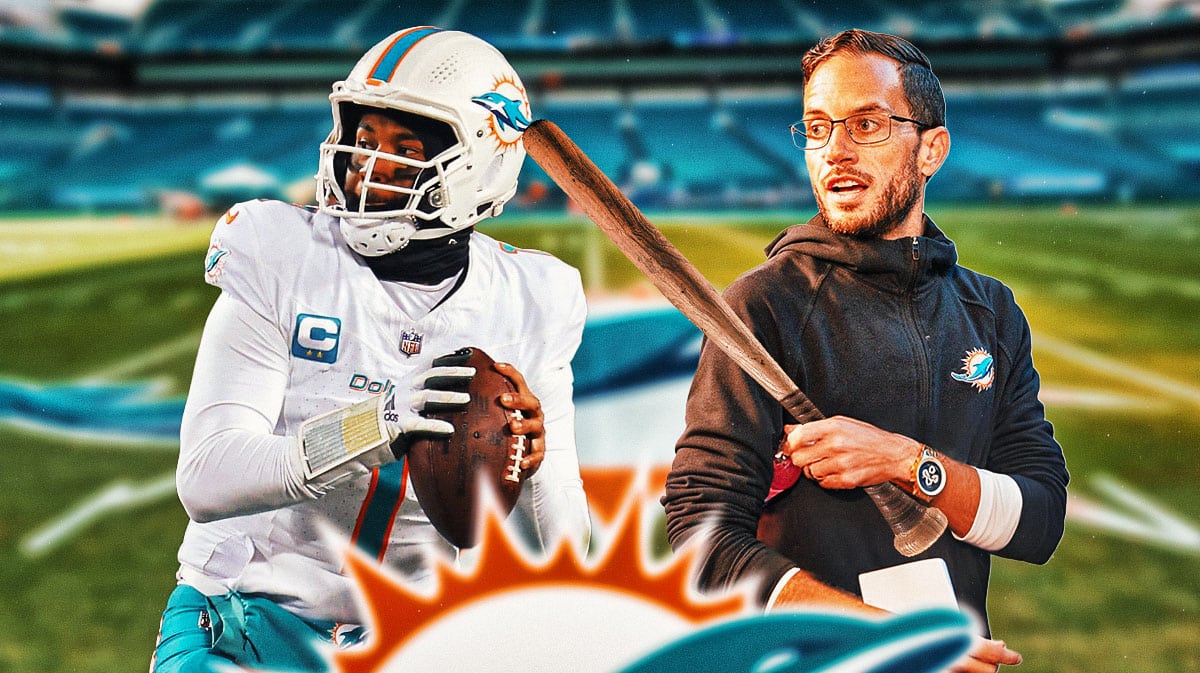 Dolphins head coach Mike McDaniel holding a bat next to Tua Tagovailoa