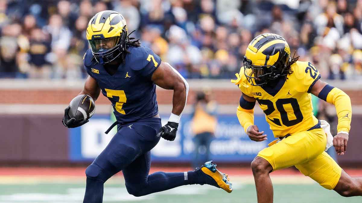 Blue Team running back Donovan Edwards (7) runs against Maize Team defensive back Jyaire Hill (20) during the first half of the spring game at Michigan Stadium