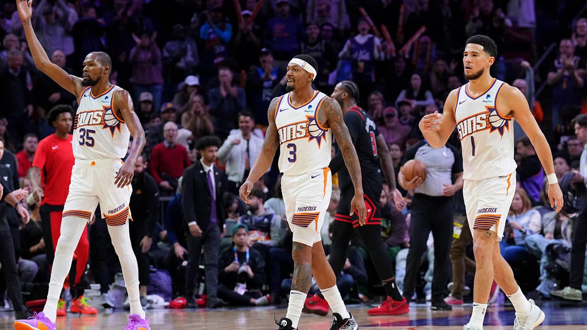 Phoenix Suns forward Kevin Durant (35) and Phoenix Suns guard Bradley Beal (3) and Phoenix Suns guard Devin Booker (1) reacts during the second half of the game against the Chicago Bulls at Footprint Center. 