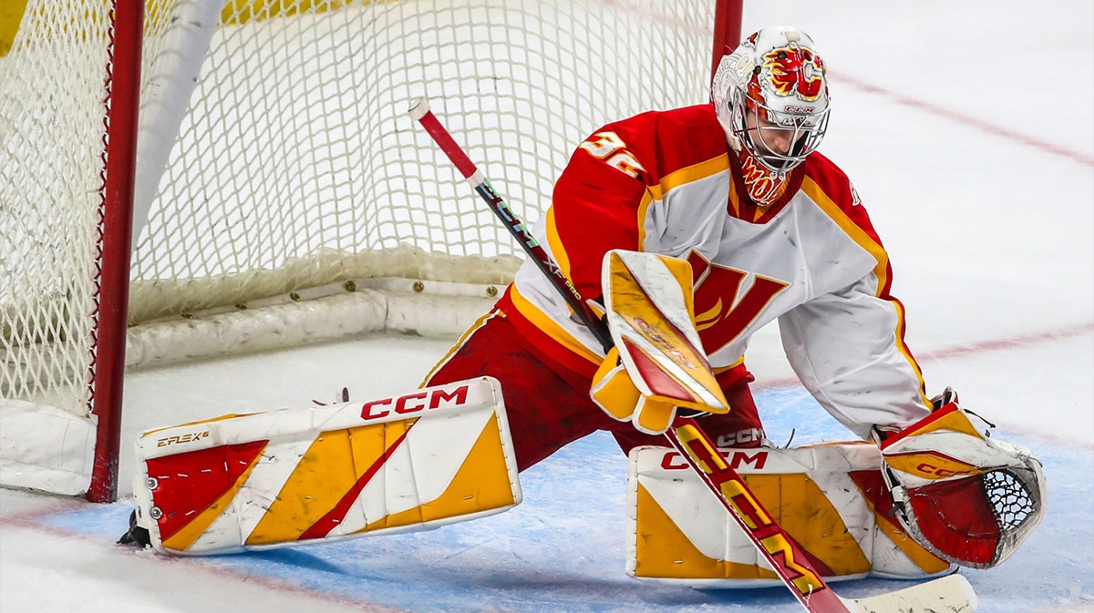 Calgary goaltender Dustin Wolf (32) blocks a shot during the third period of Game 3 of the Pacific Division semifinals at Acrisure Arena in Palm Desert, Calif., Wednesday, May 8, 2024.