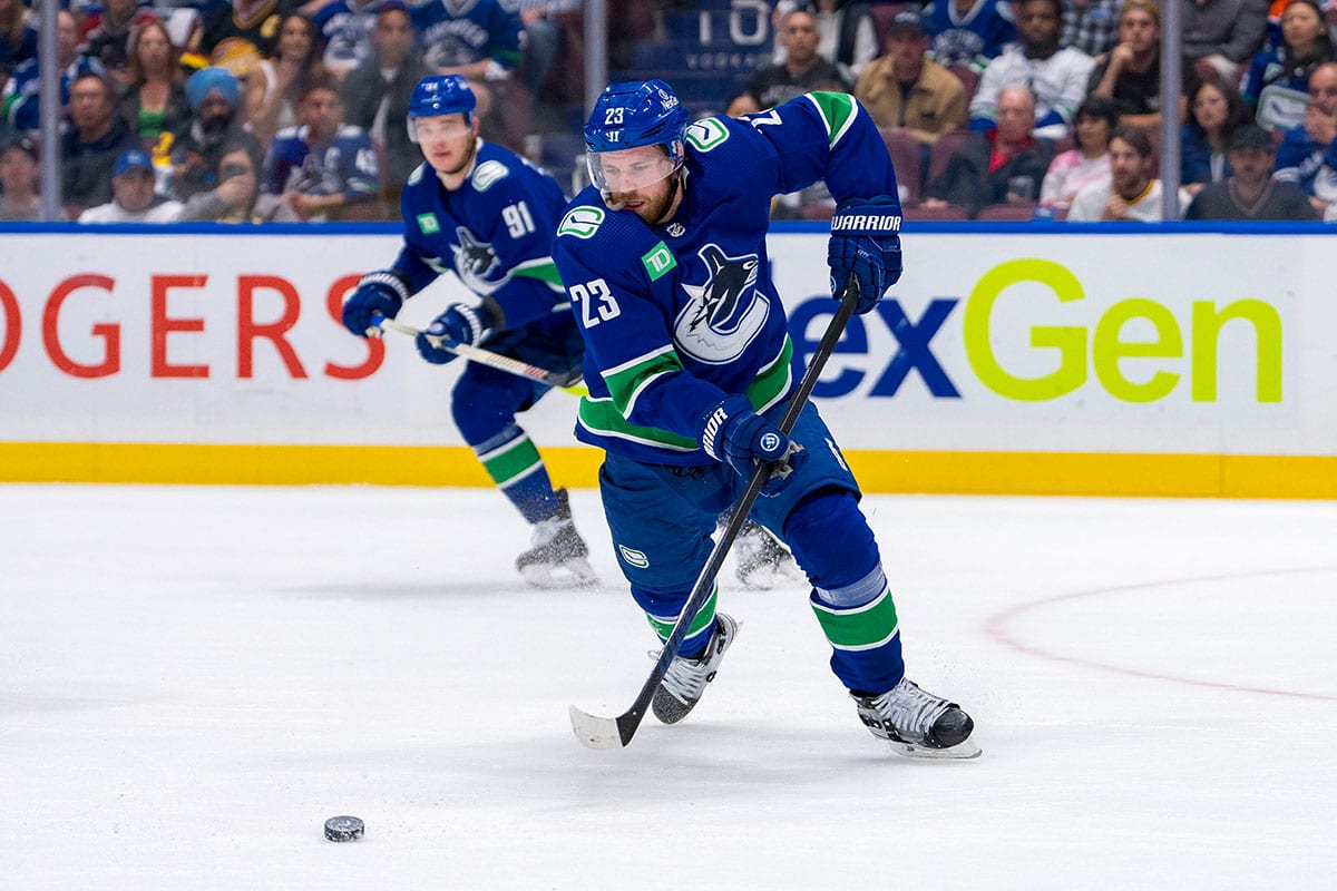  Vancouver Canucks forward Elias Lindholm (23) handles the puck against the Edmonton Oilers during the first period in game seven of the second round of the 2024 Stanley Cup Playoffs at Rogers Arena. 