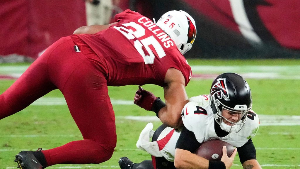 Atlanta Falcons quarterback Taylor Heinicke (4) leaves the game after this play against Arizona Cardinals linebacker Zaven Collins (25) in the second half at State Farm Stadium.