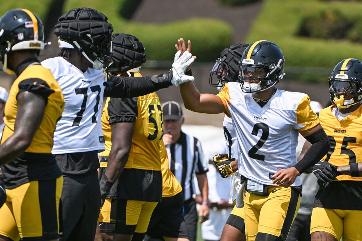 Pittsburgh Steelers quarterback Justin Fields celebrates with offensive tackle Broderick Jones (77) after scoring during training camp at Saint Vincent College.