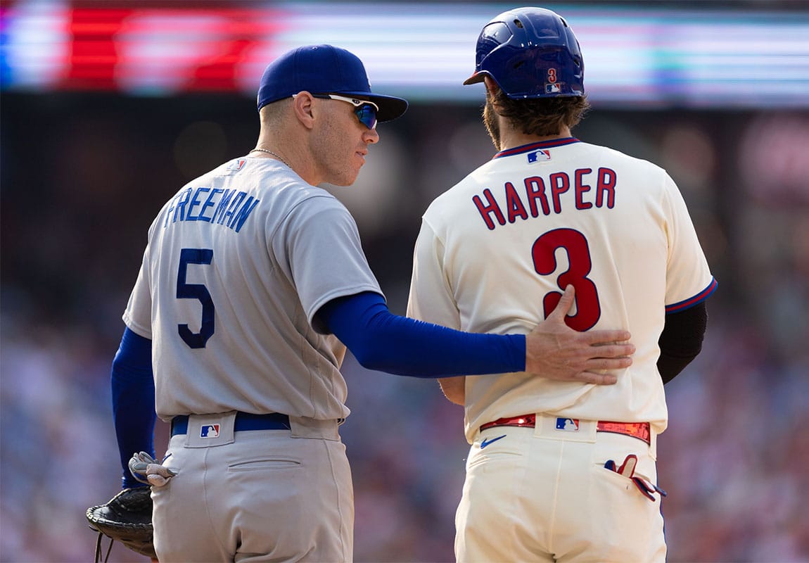 Los Angeles Dodgers first baseman Freddie Freeman (5) talks with Philadelphia Phillies designated hitter Bryce Harper (3) after Harper walked during the sixth inning at Citizens Bank Park.