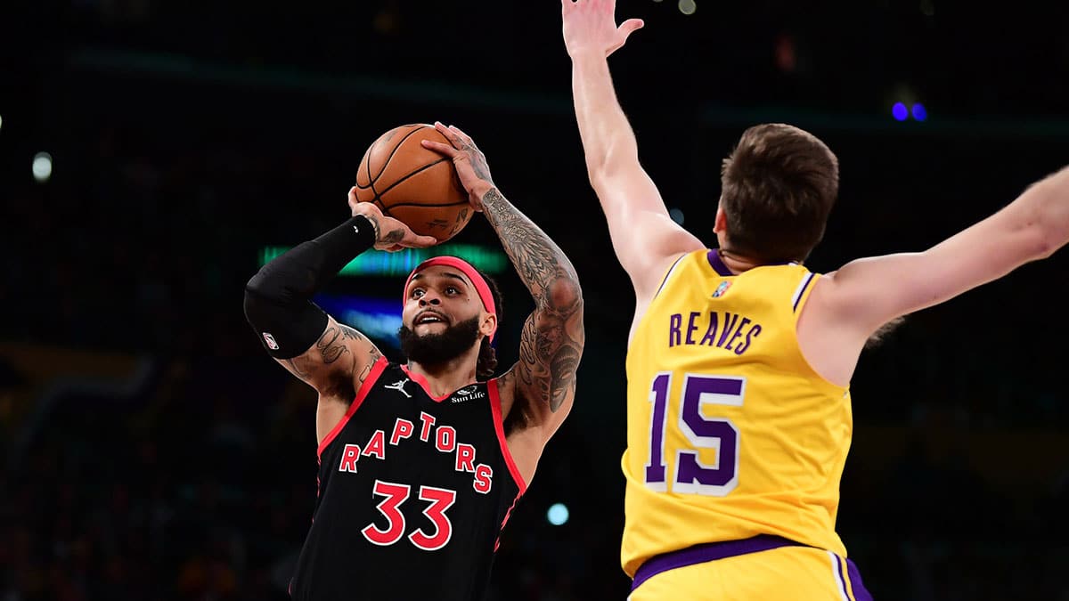 Mar 14, 2022; Los Angeles, California, USA; Toronto Raptors guard Gary Trent Jr. (33) shoots against Los Angeles Lakers guard Austin Reaves (15) during the first half at Crypto.com Arena. Mandatory Credit: Gary A. Vasquez-USA TODAY Sports
