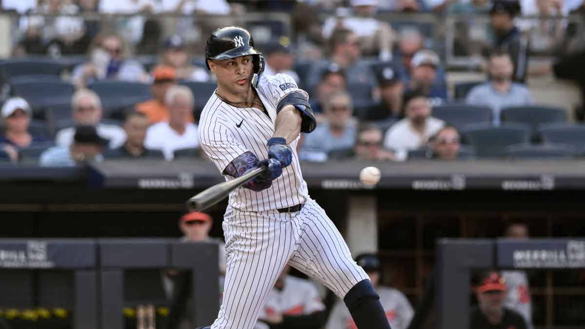 Jun 20, 2024; Bronx, New York, USA; New York Yankees designated hitter Giancarlo Stanton (27) hits a single during the fifth inning against the Baltimore Orioles at Yankee Stadium. 