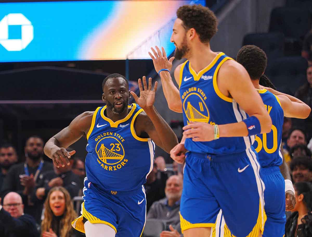 Nov 30, 2023; San Francisco, California, USA; Golden State Warriors forward Draymond Green (23) celebrates with guard Klay Thompson (11) and guard Stephen Curry (30) after scoring a basket against the Los Angeles Clippers during ring the first quarter at Chase Center. Mandatory Credit: Kelley L Cox-USA TODAY Sports