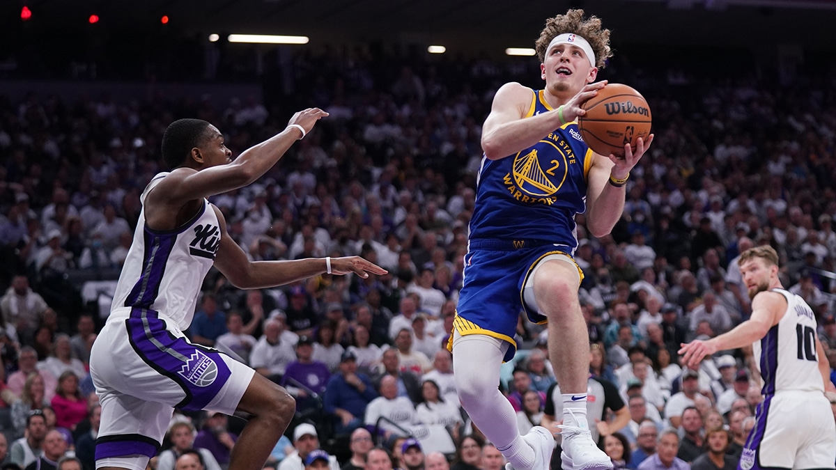 Apr 16, 2024; Sacramento, California, USA; Golden State Warriors guard Brandin Podziemski (2) makes a layup next to Sacramento Kings guard De'Aaron Fox (5) in the second quarter during a play-in game of the 2024 NBA playoffs at the Golden 1 Center. Mandatory Credit: Cary Edmondson-USA TODAY Sports