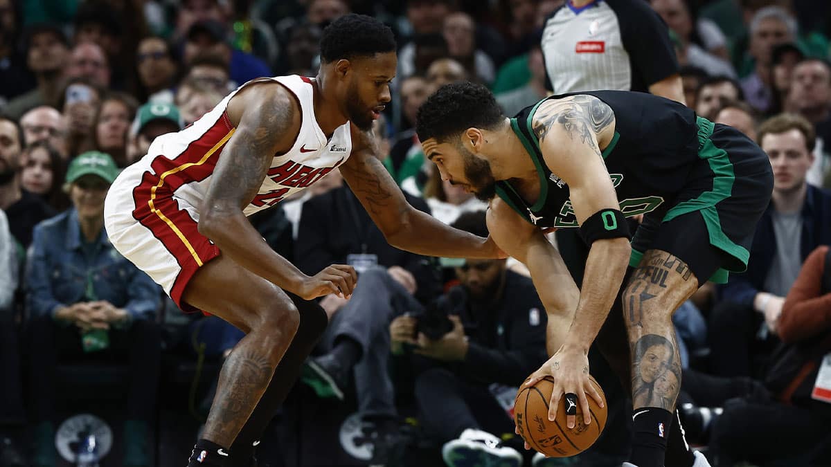 Boston Celtics forward Jayson Tatum (0) looks for a way around Miami Heat forward Haywood Highsmith (24) during the first quarter of game five of the first round of the 2024 NBA playoffs at TD Garden.