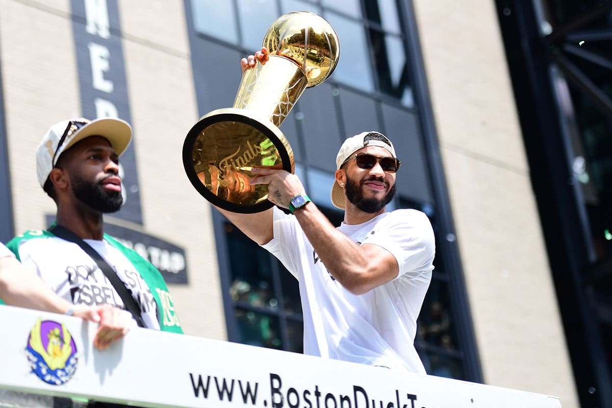 Boston Celtics player Jayson Tatum holds the Larry OíBrien trophy during the Boston Celtics Championship parade.