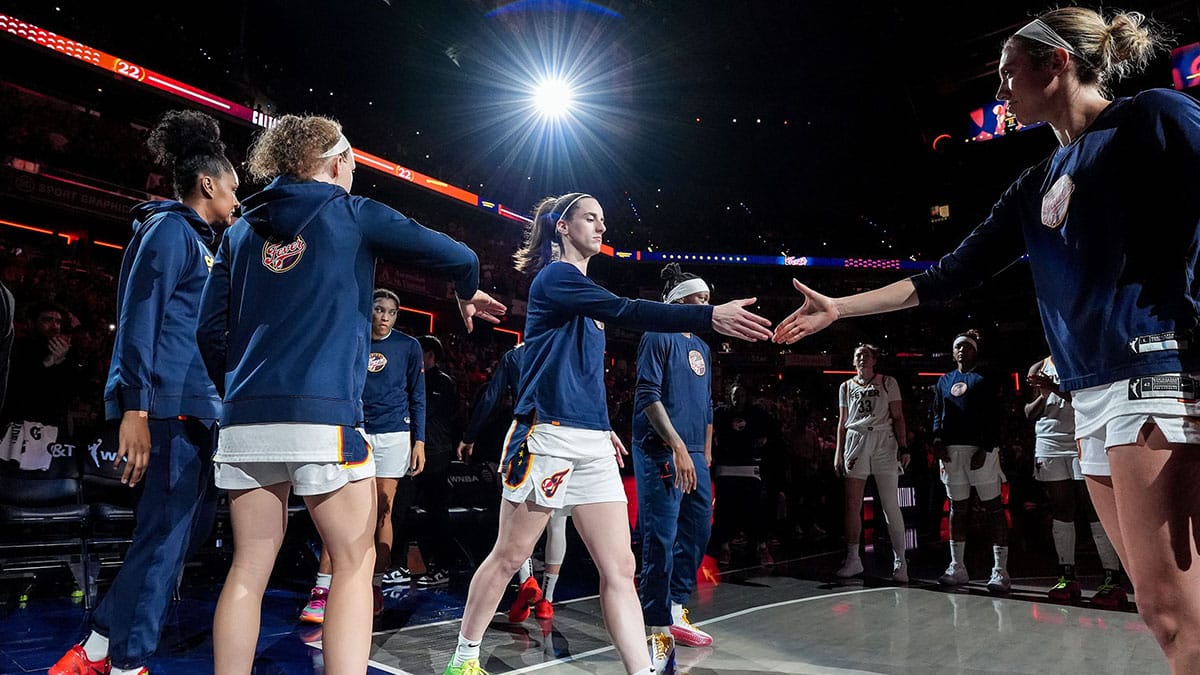 Indiana Fever guard Caitlin Clark (22) shakes hands with Indiana Fever guard Lexie Hull (10) during team introductions on Friday, July 12, 2024, during the game at Gainbridge Fieldhouse in Indianapolis. The Indiana Fever defeated the Phoenix Mercury, 95-86.