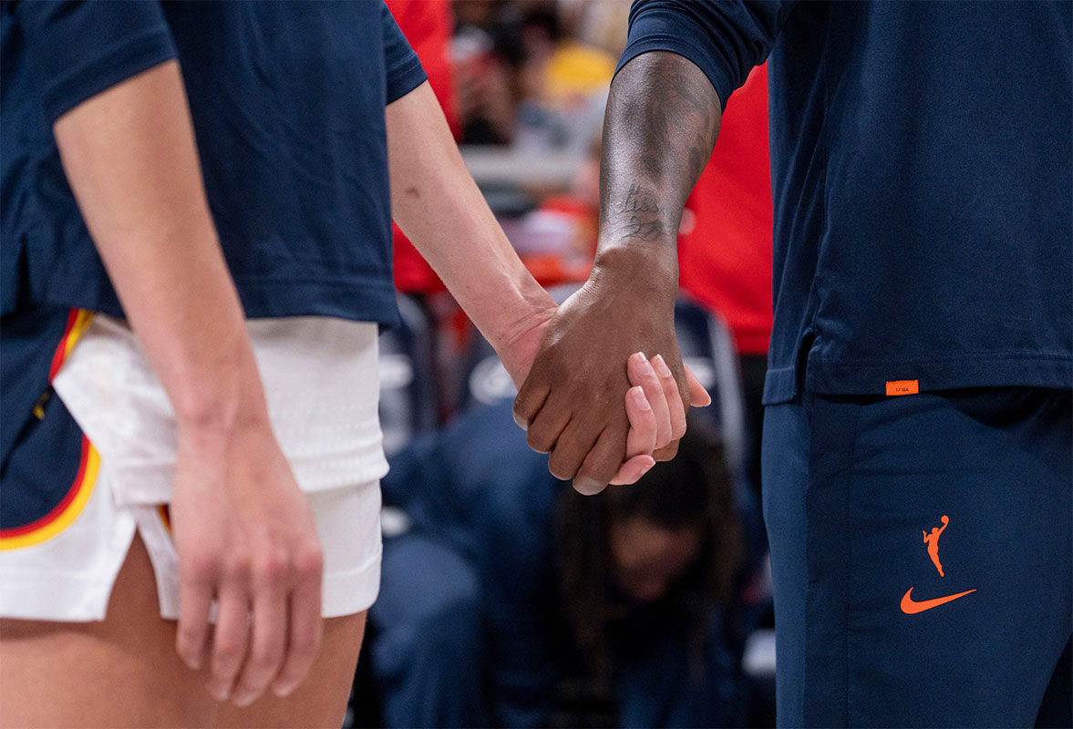 Indiana Fever guard Lexie Hull (10) and Indiana Fever guard Erica Wheeler (17) hold hands during a Juneteenth celebration. The Indiana Fever defeated the Washington Mystics, 88 - 81.