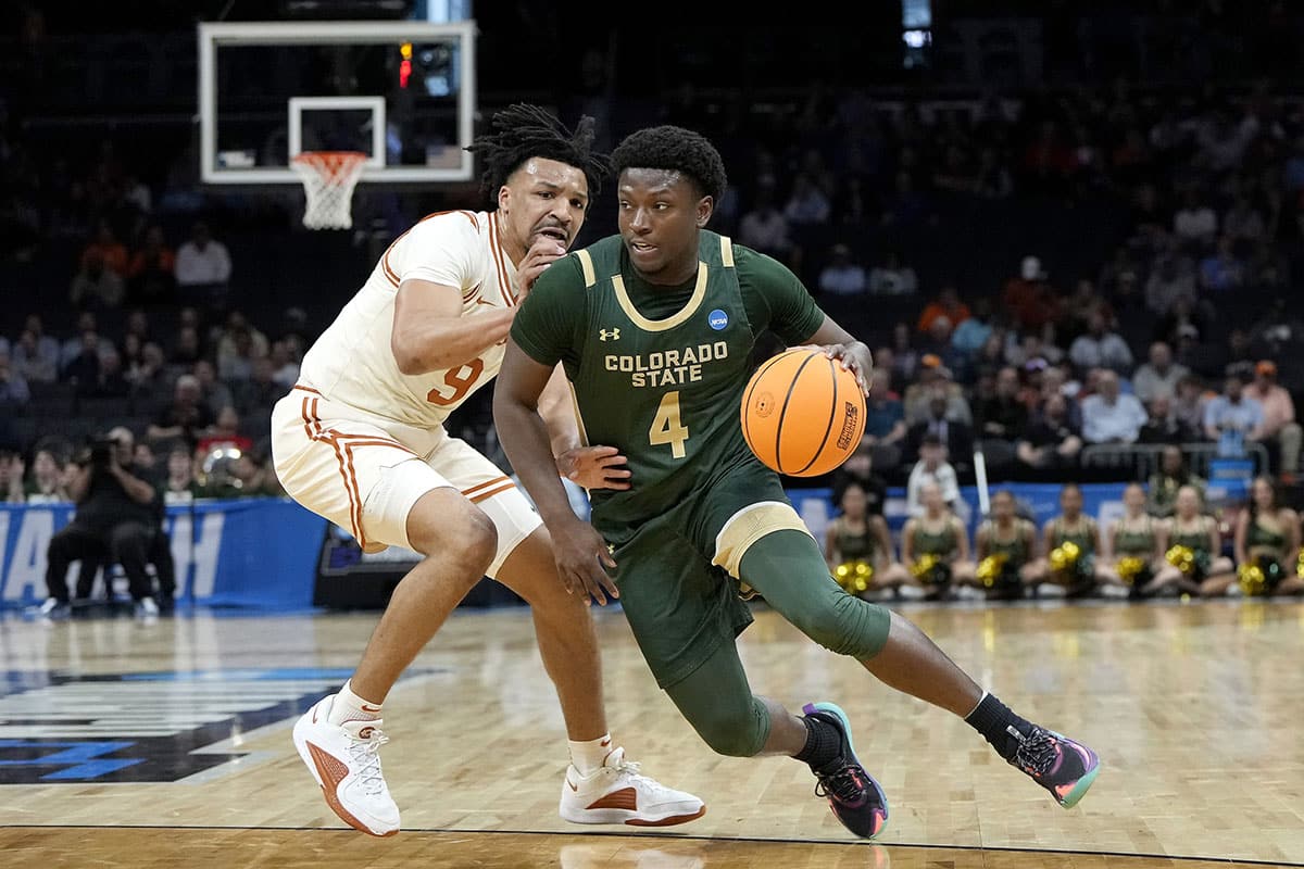 Colorado State Rams guard Isaiah Stevens (4) dribbles around Texas Longhorns guard Ithiel Horton (9) in the first half of the first round of the 2024 NCAA Tournament at Spectrum Center. 