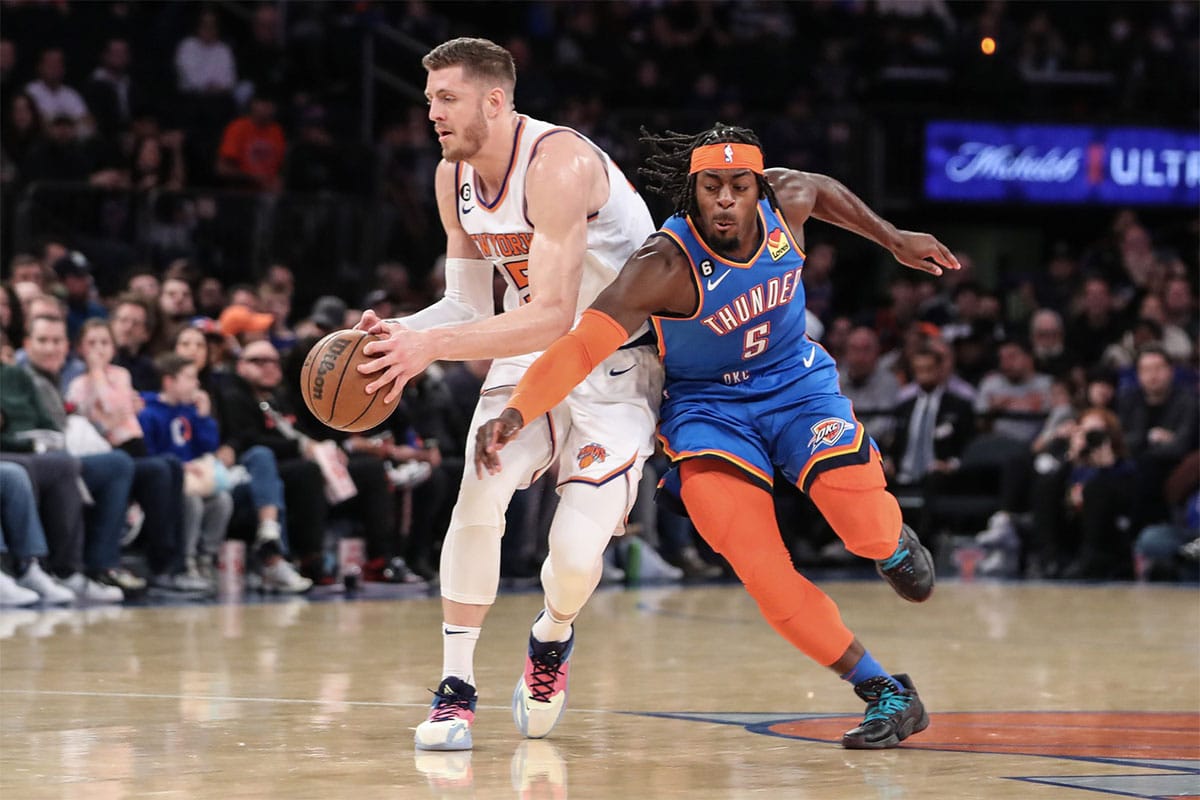 Oklahoma City Thunder forward Luguentz Dort (5) tries to steal the ball form New York Knicks center Isaiah Hartenstein (55) in the first half at Madison Square Garden. 