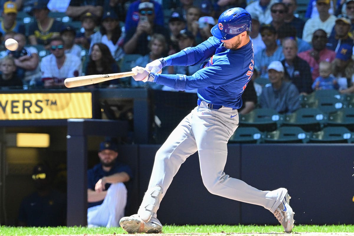 Chicago Cubs designated hitter Cody Bellinger (24) hits a single against the Milwaukee Brewers in the first inning at American Family Field. 