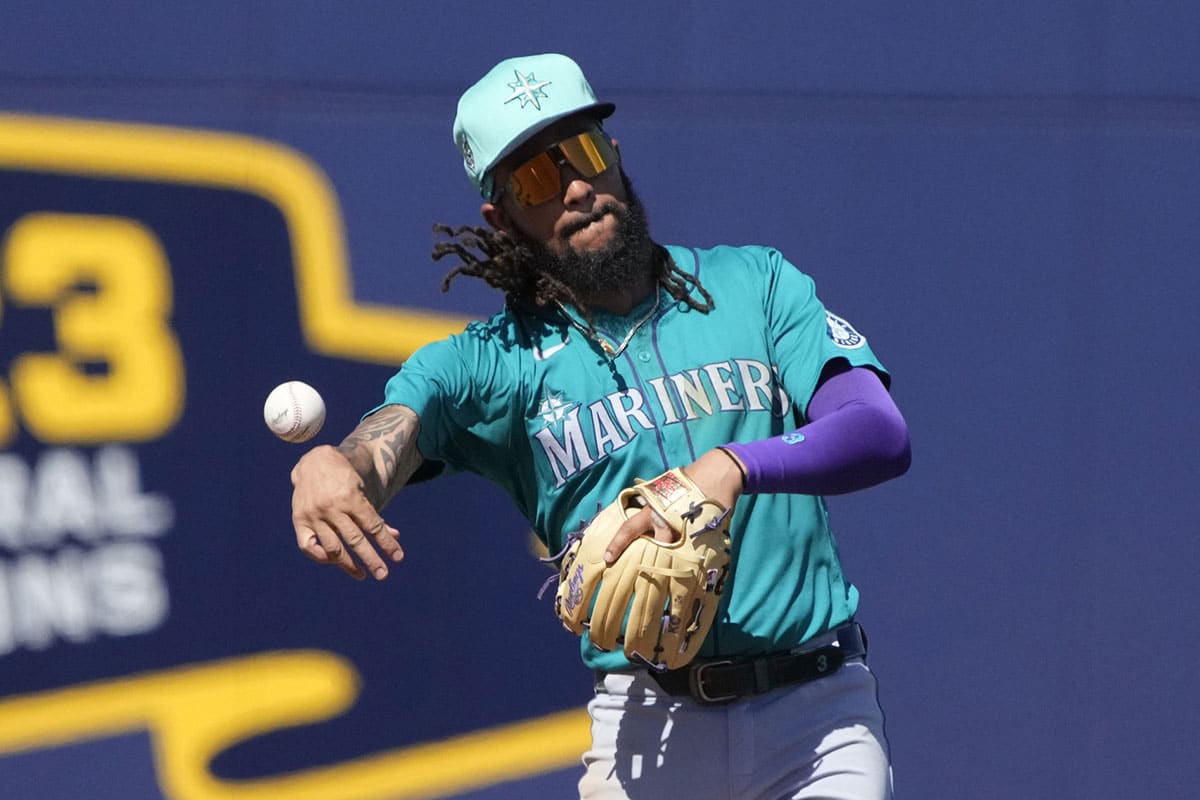 Mar 9, 2024; Phoenix, Arizona, USA; Seattle Mariners shortstop JP Crawford (3) flips the ball for an out against the Milwaukee Brewers in the third inning at American Family Fields of Phoenix. 