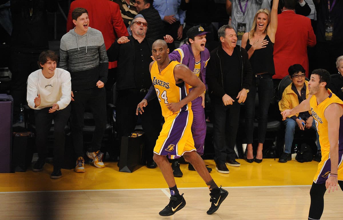 Los Angeles Lakers forward Kobe Bryant (24) runs by after scoring a basket as film actor Jack Nicholson reacts against Utah Jazz during the second half at Staples Center. 