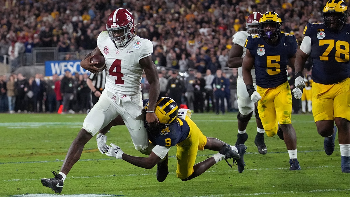 Alabama Crimson Tide quarterback Jalen Milroe (4) is tackled by Michigan Wolverines defensive back Rod Moore (9) during overtime in the 2024 Rose Bowl college football playoff semifinal game at Rose Bowl.