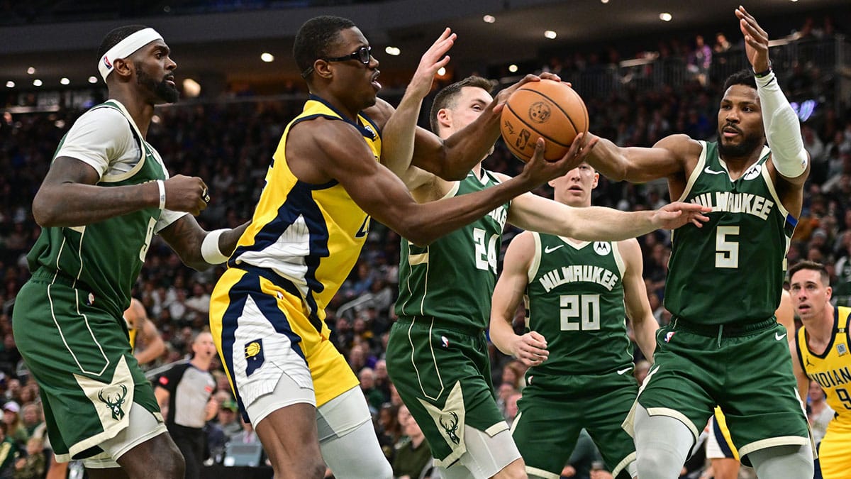 Indiana Pacers forward Jalen Smith (25) and Milwaukee Bucks guard Malik Beasley (5) reach for the ball in the in the third quarter during game one of the first round for the 2024 NBA playoffs at Fiserv Forum.
