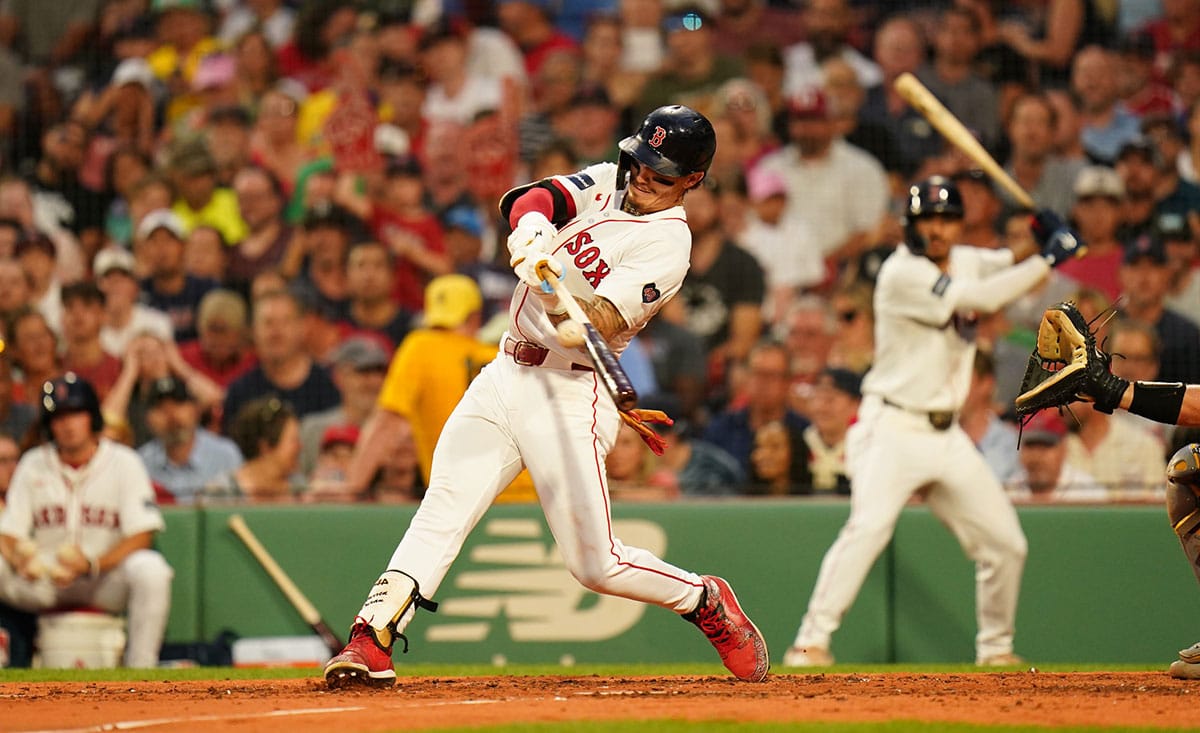 Boston Red Sox center fielder Jarren Duran (16) hits a sacrifice fly to drive in a run against the Oakland Athletics in the second inning at Fenway Park.