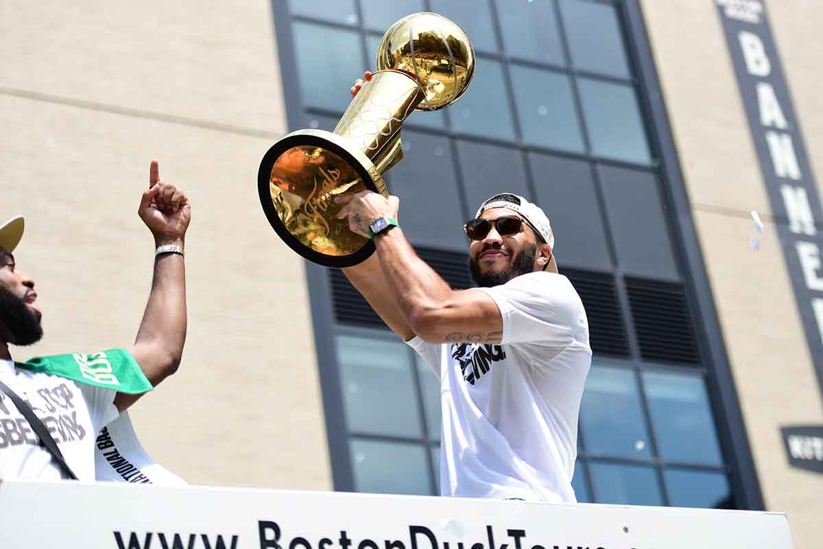 Boston Celtics player Jayson Tatum holds the Larry OíBrien trophy during the Boston Celtics Championship parade