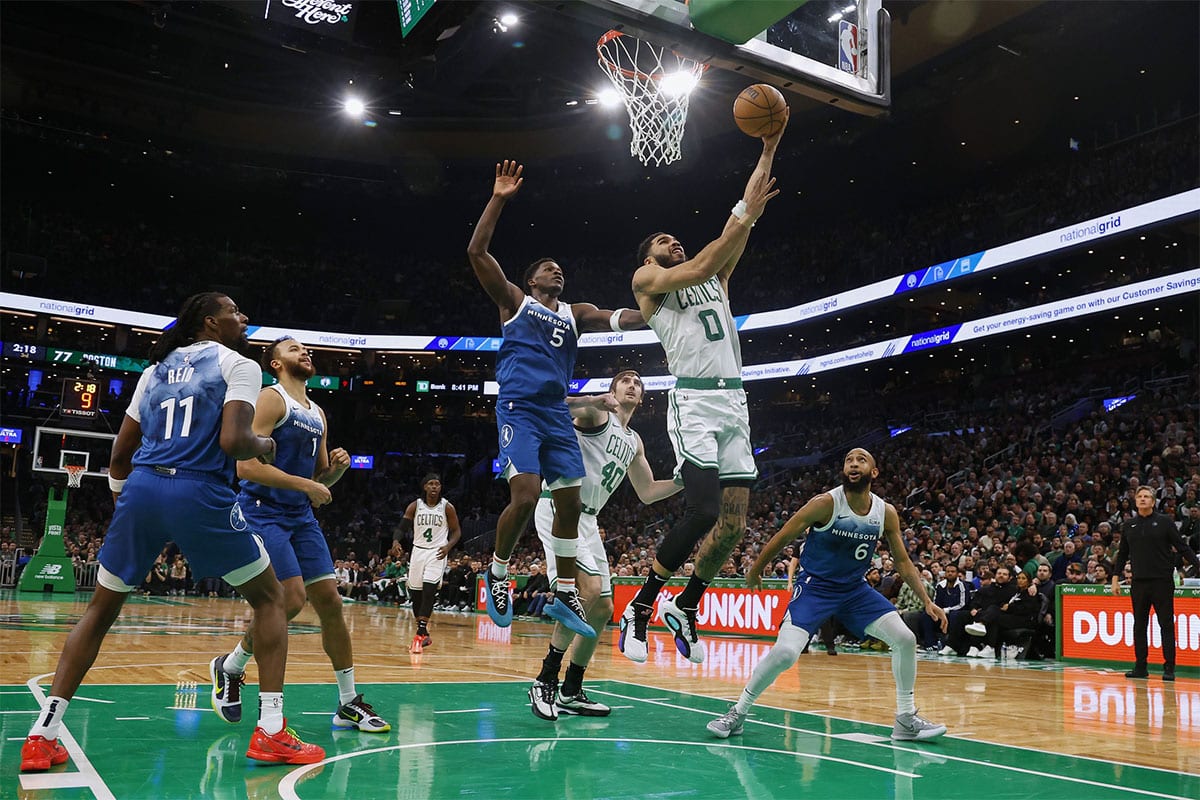 Boston Celtics forward Jayson Tatum (0) goes to the basket past Minnesota Timberwolves guard Anthony Edwards (5) during the second half at TD Garden. 