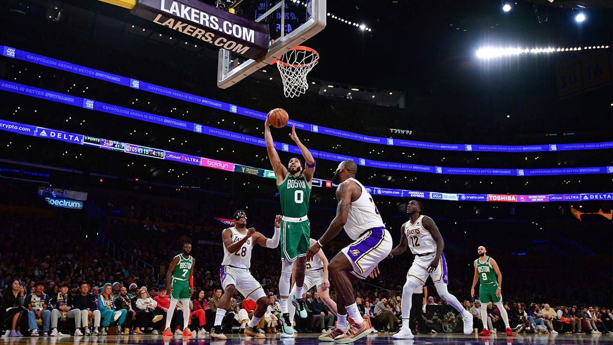 Boston Celtics forward Jayson Tatum (0) moves to the basket against Los Angeles Lakers forward LeBron James (23) and forward Rui Hachimura (28) during the second half at Crypto.com Arena. 
