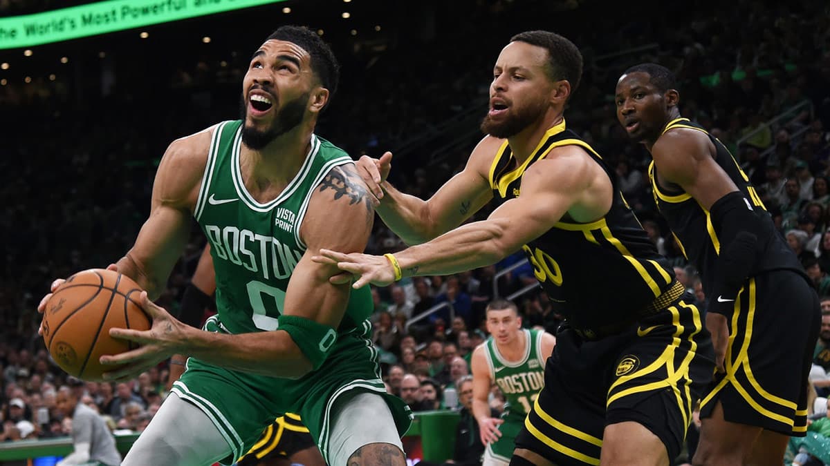 Boston Celtics forward Jayson Tatum (0) controls the ball while Golden State Warriors guard Stephen Curry (30) defends during the first half at TD Garden.