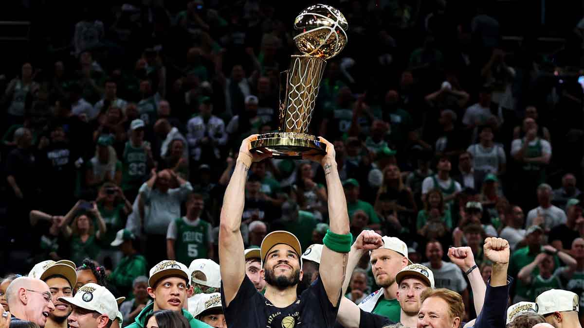 Boston Celtics forward Jayson Tatum (0) celebrates with the Larry O’Brian Trophy after beating the Dallas Mavericks in game five of the 2024 NBA Finals to win the NBA Championship at TD Garden. Mandatory Credit: Peter Casey-USA TODAY SportsJun 17, 2024; Boston, Massachusetts, USA; xxxxxx in game five of the 2024 NBA Finals at TD Garden. 