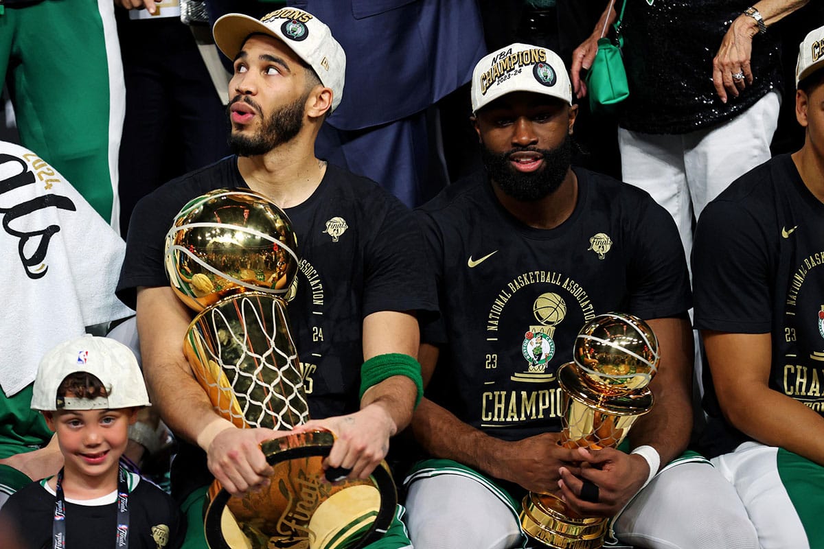 Boston Celtics forward Jayson Tatum (0) and guard Jaylen Brown (7) celebrates with the Larry O’Brian Trophy after beating the Dallas Mavericks in game five of the 2024 NBA Finals to win the NBA Championship at TD Garden.