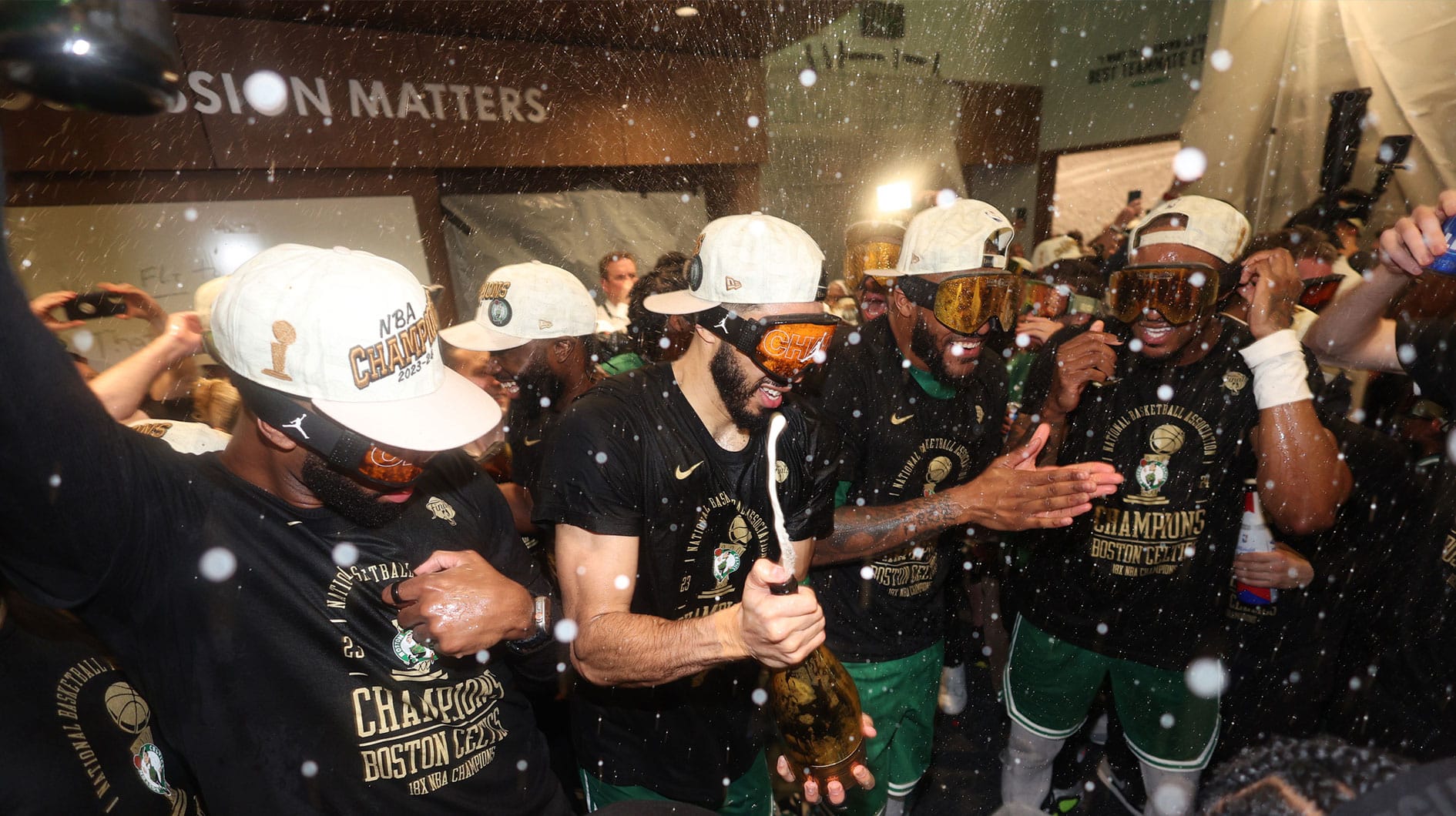  Boston Celtics forward Jayson Tatum (center) celebrates in the locker room after winning the 2024 NBA Finals against the Dallas Mavericks at TD Garden. 