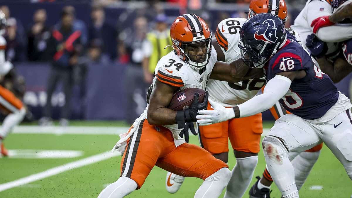 Jan 13, 2024; Houston, Texas, USA; Cleveland Browns running back Jerome Ford (34) and Houston Texans linebacker Christian Harris (48) fight for the ball during the second quarter in a 2024 AFC wild card game at NRG Stadium.