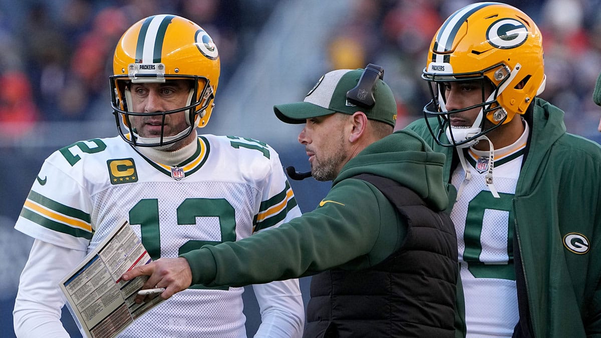 Green Bay Packers quarterback Aaron Rodgers (12) and quarterback Jordan Love (10) listen to head coach Matt LaFleur during the fourth quarter of their game Sunday, December 4, 2022 at Soldier Field in Chicago, Ill. 
